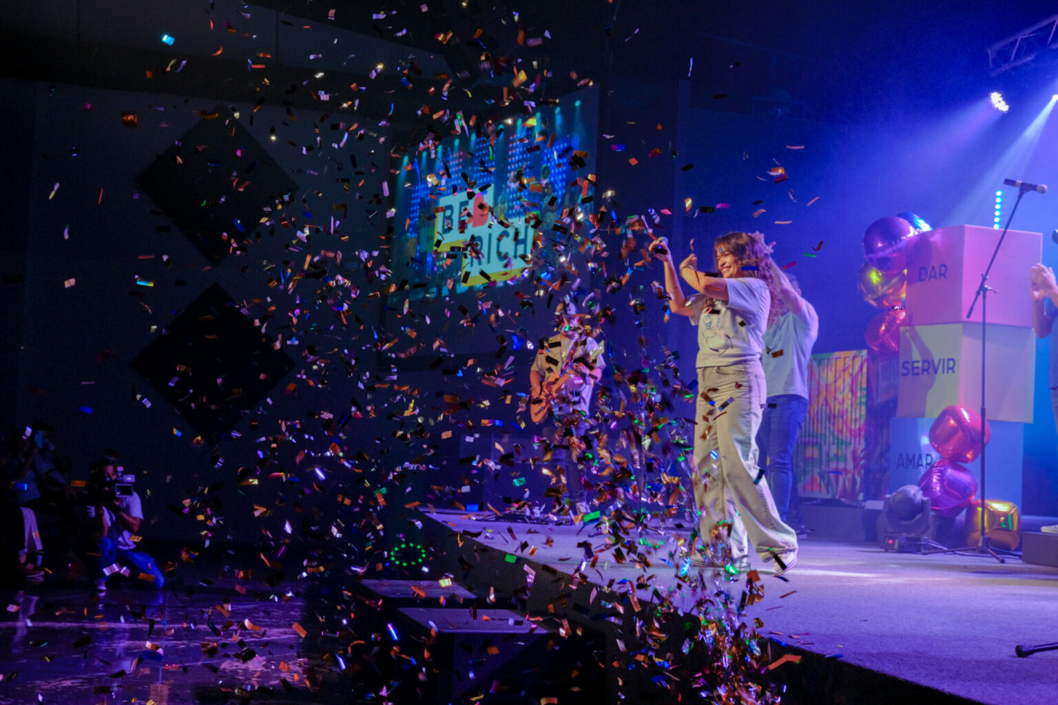 Confetti falling over the stage at the end of an event