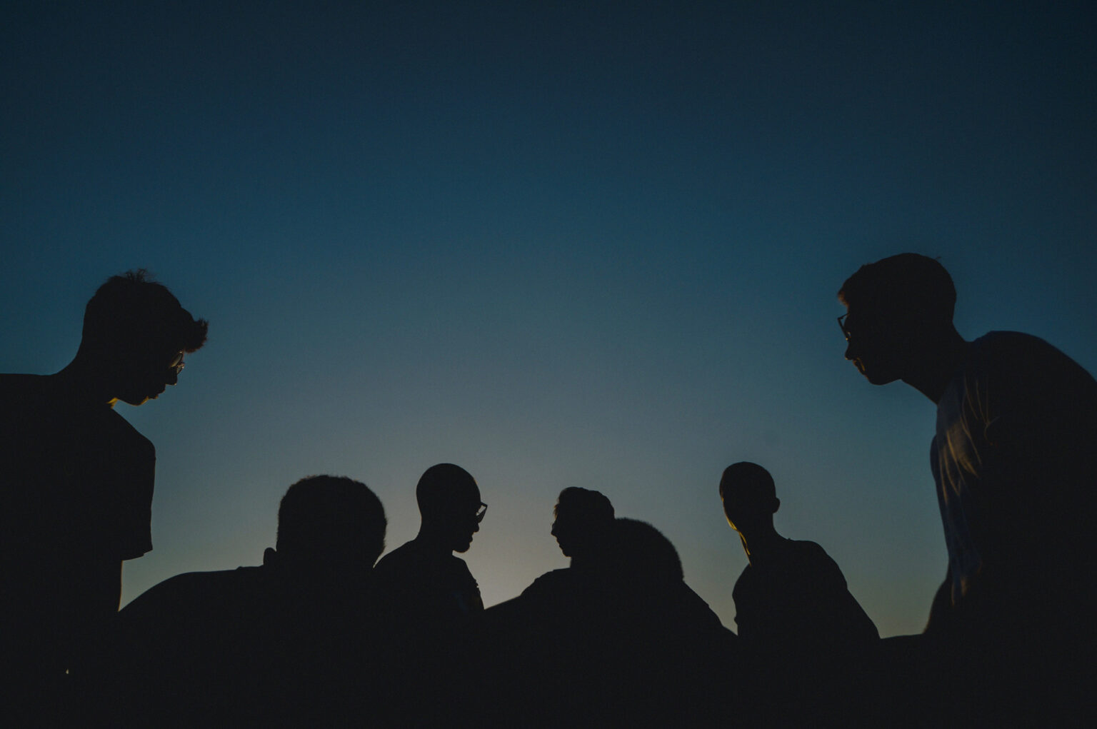 Students in silhouette at sunset