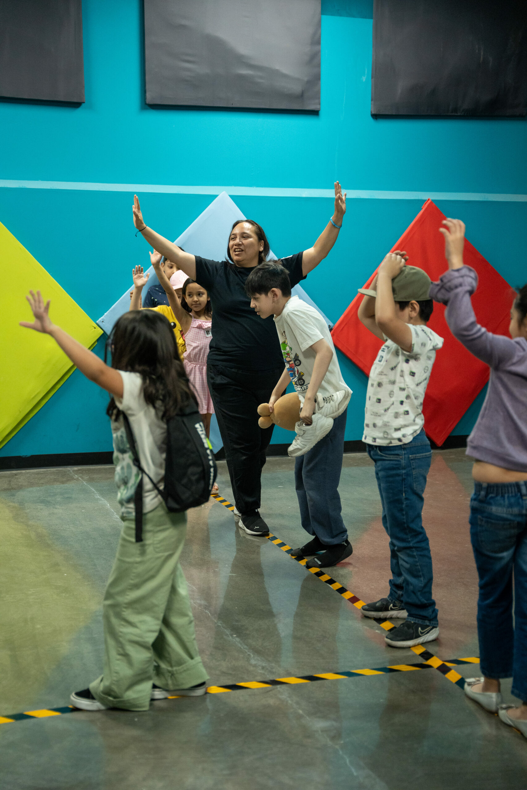 Kids in front of a colorful wall in the kids space