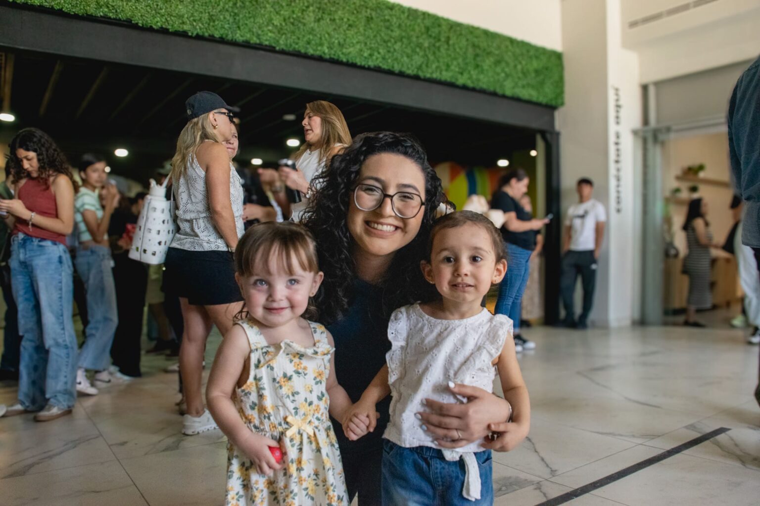 A mom with her two little daughters in the lobby