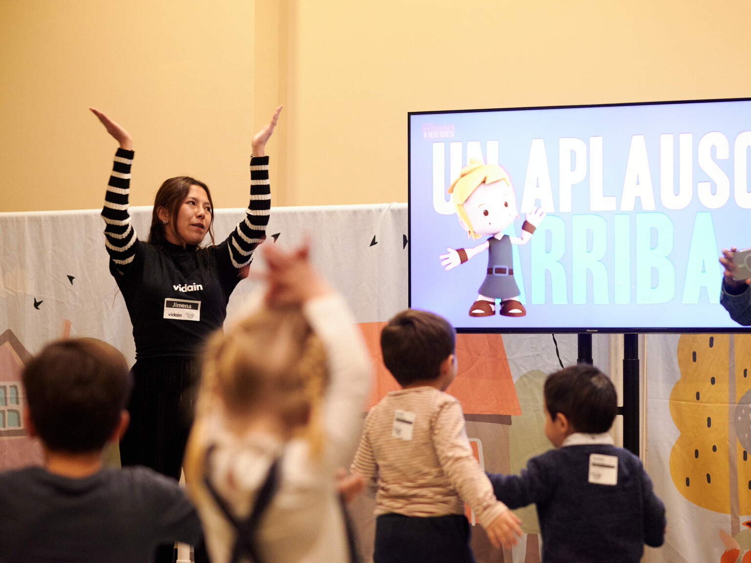 Kids raising their hands in the vidain kids space