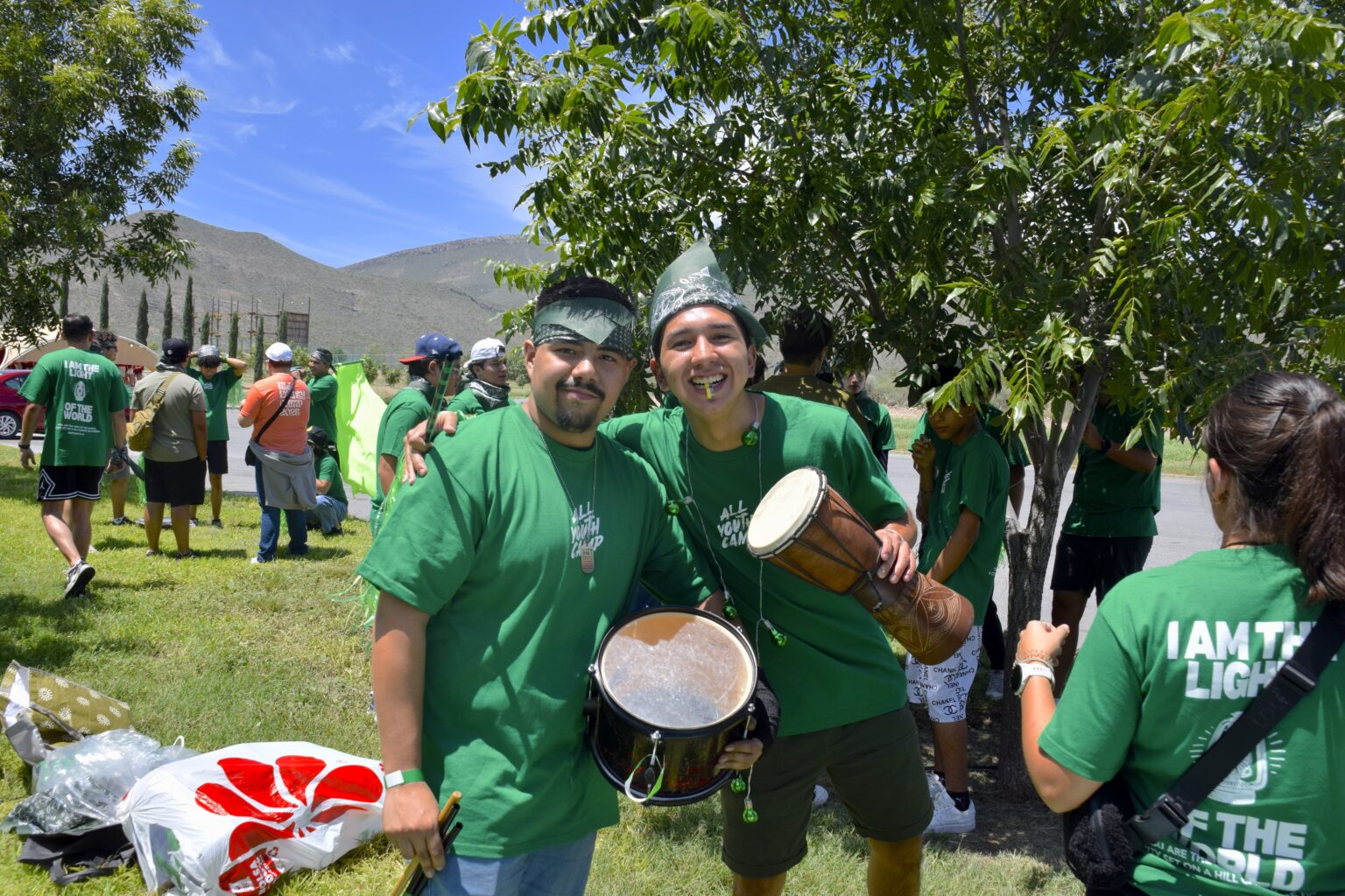 A volunteer playing a drum during camp