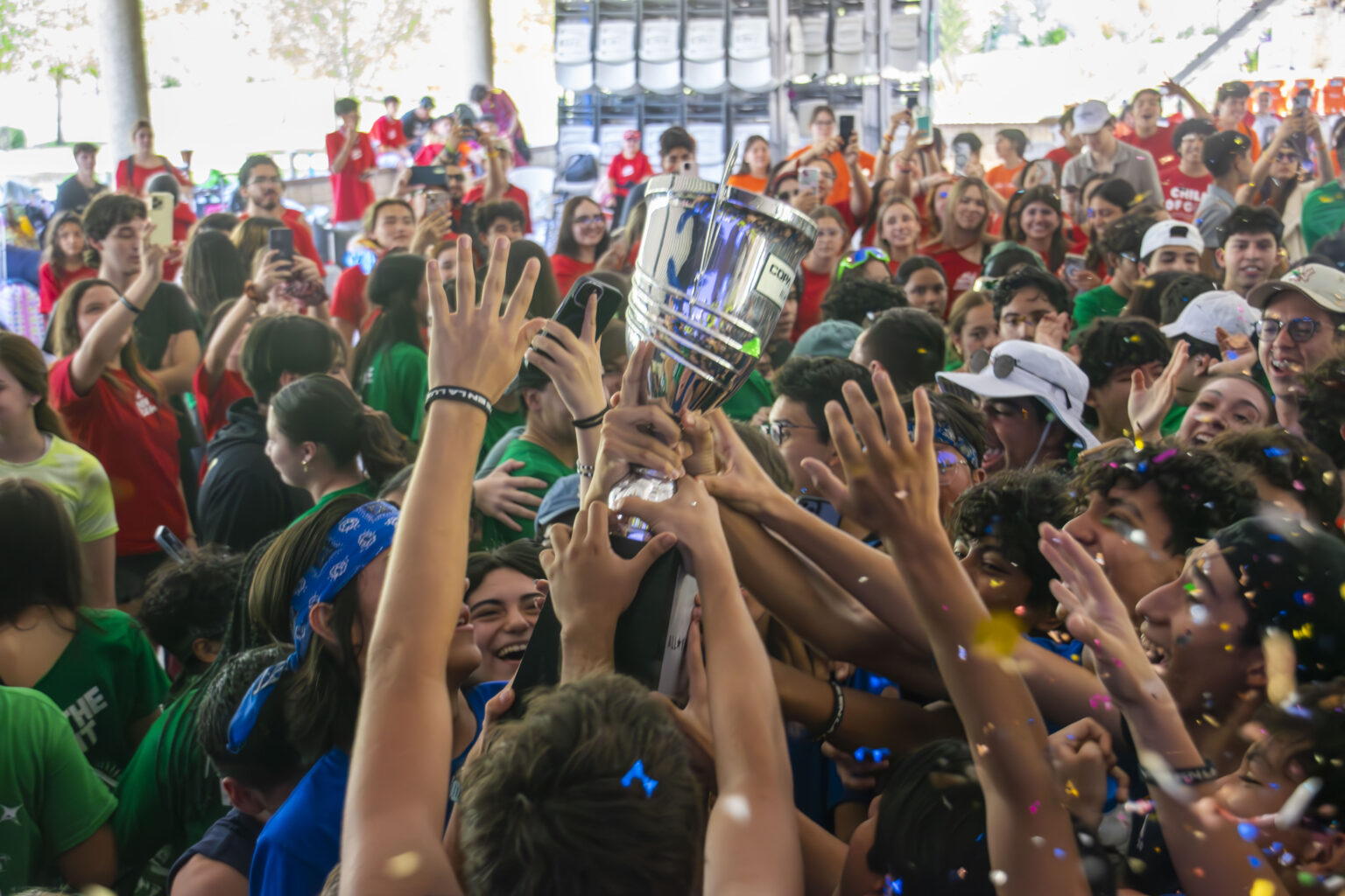 Young people celebrating with their hands up at All Youth Camp