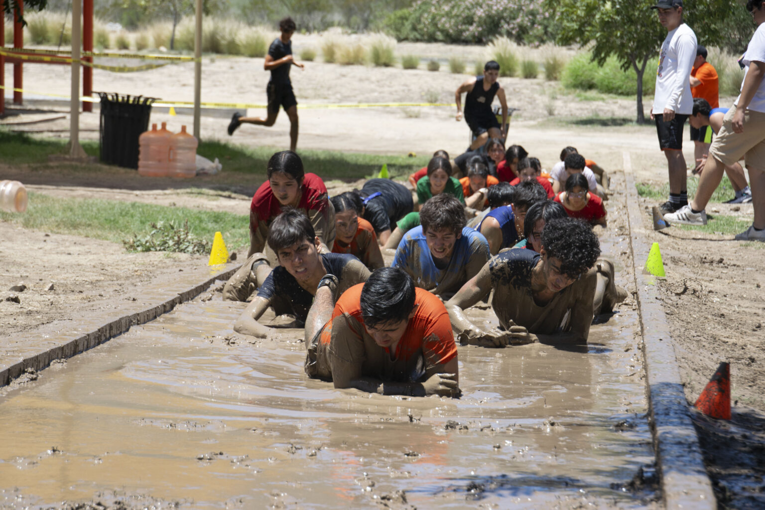 Students in a mud obstacle course