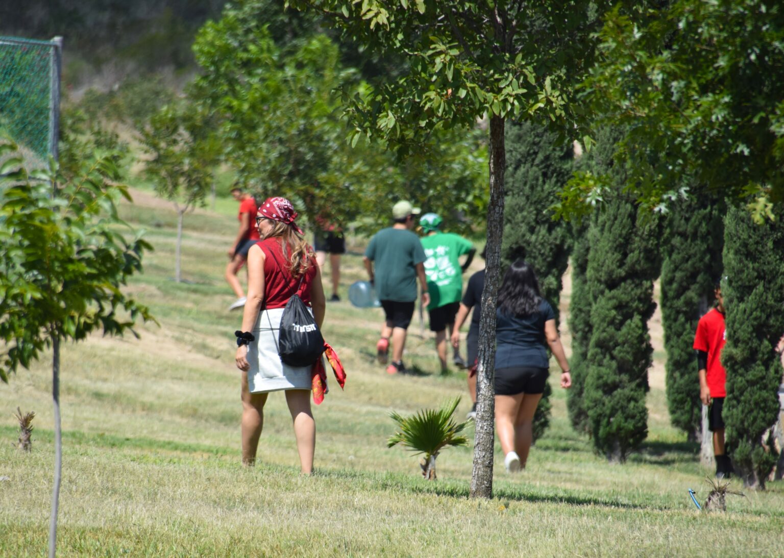 Young people walking among the trees at camp